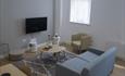 Living area with dining table and TV in the room at Stay Cove hotel, Piccadilly, Manchester