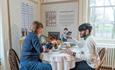 People drinking tea at a table at Elizabeth Gaskell's House