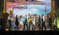 Actors and guitarist on stage at Fairytale of New York