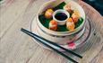 Freshly prepared food served in a bowl with chopsticks