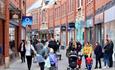 Shoppers walking along high street in Prince Bishop's Palace