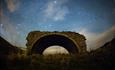 Old broken bridge and starry night sky