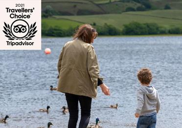 A mother and child feeding ducks at Hollingworth Lake.