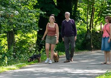 A family walking through Queen's Park.