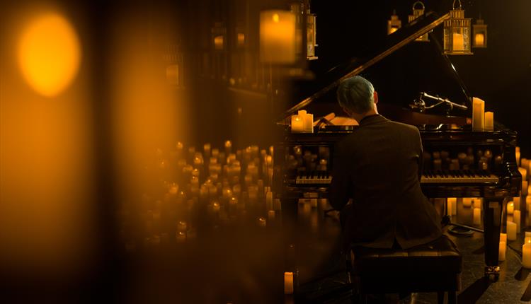 Piano player, surrounded by candles
