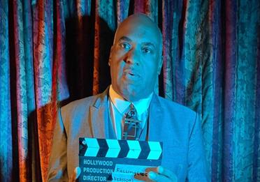 Dominic Pillai holding film clapperboard