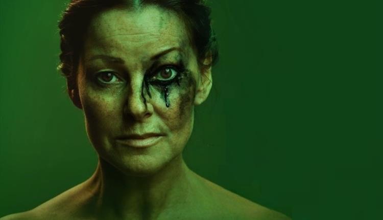 Woman with green paint on her face