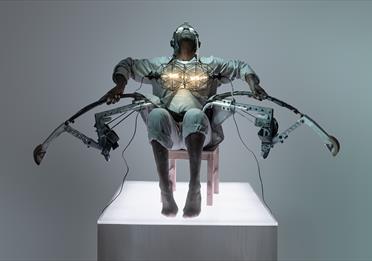 Benji Reid sat in a chair in a dystopian costume