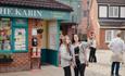 2 people posing for a photo outside of The Kabin on the Coronation Street tour in Manchester