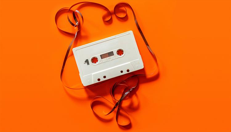 White cassette on orange background