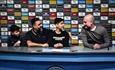 Fans sit with a virtual Pep Guardiola at the Manchester City Stadium Tour