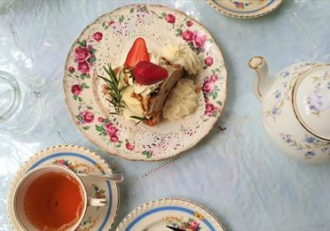 Afternoon tea and cakes presented on china plates