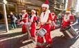 Band dressed in festive outfits in Manchester City Centre