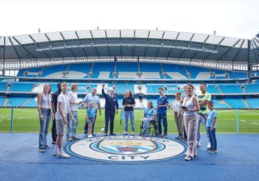 Group of fans inside the Etihad Stadium on a tour