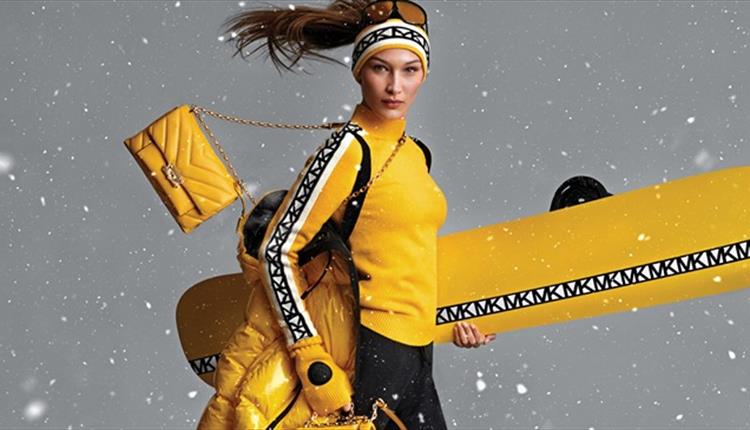 Model wearing Michael Kors ski wear and accessories.