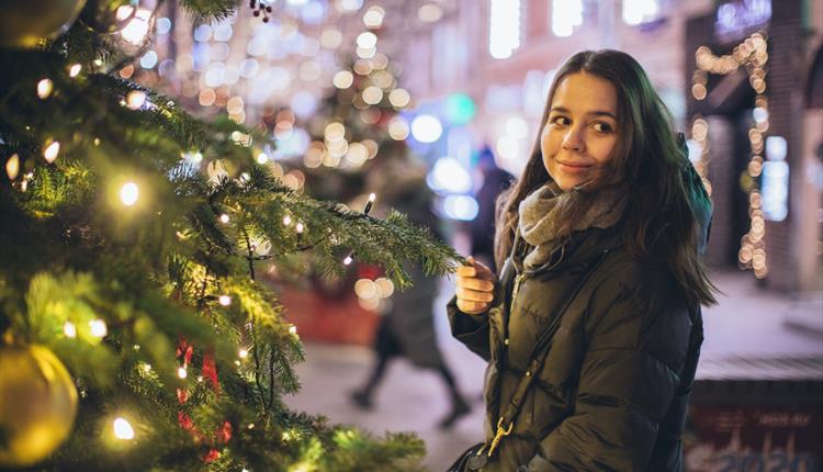 Woman next to Christmas decorations