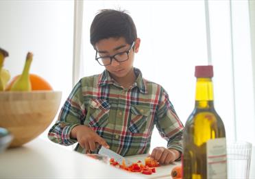 Boy Slicing Tomatoes
