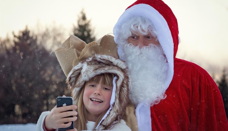 Father Christmas taking selfie with a girl