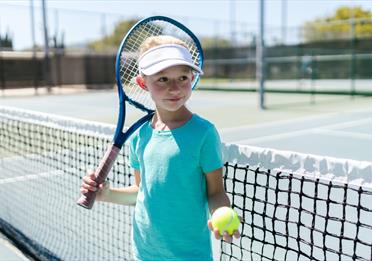 Girl Wearing Sportswear Standing by the Tennis Net