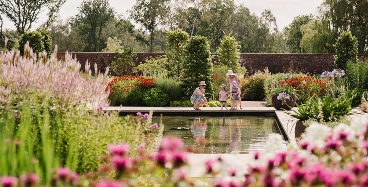 Family overlooking a small pond at RHHS Garden Bridgewater