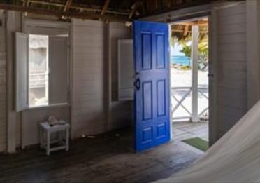 photo of house door opening onto a beach