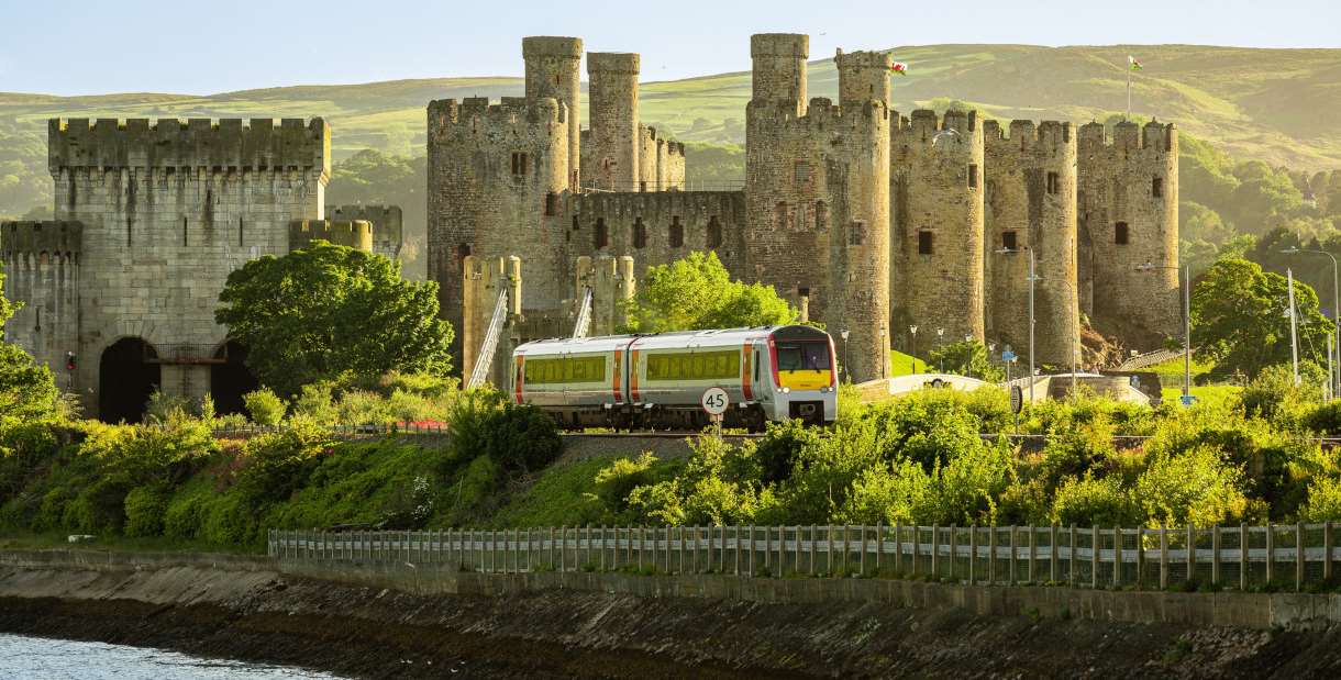 Train on the tracks in front of a castle