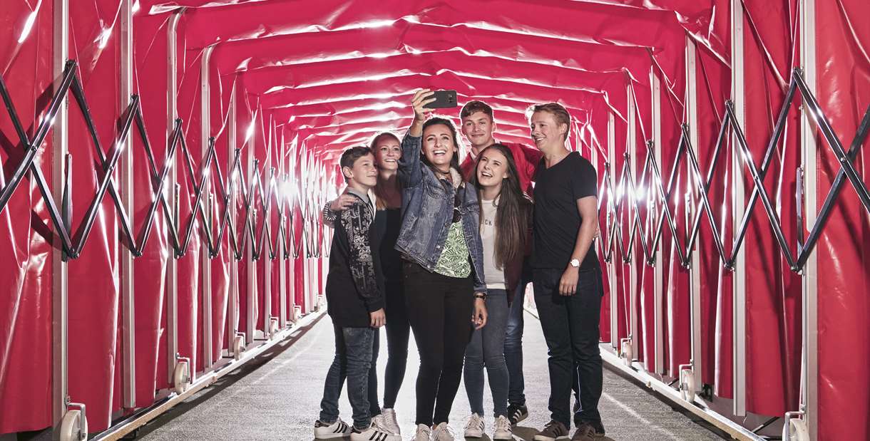 Family taking a selfie in the tunnel at the Manchester United Museum and Stadium Tour