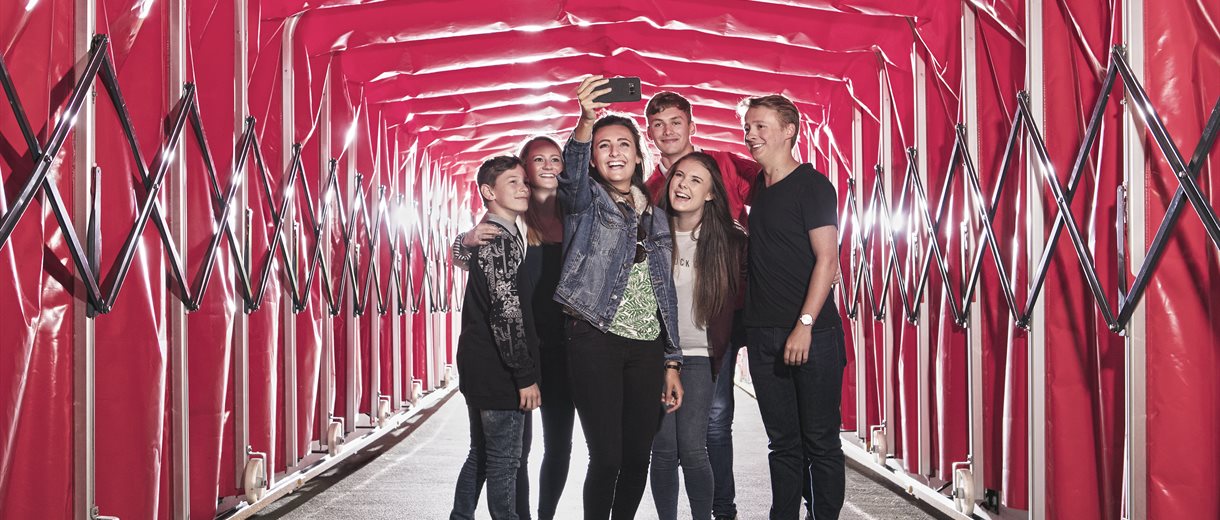 Family taking a selfie in the tunnel at the Manchester United Museum and Stadium Tour