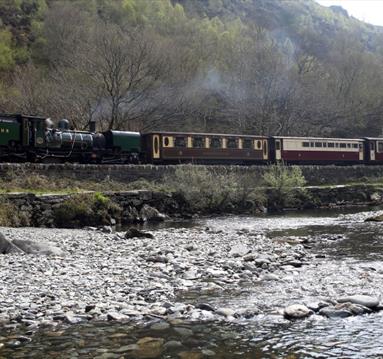 Train on the West Highland Railway, with river in front