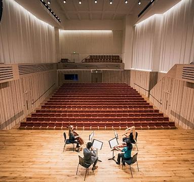 four musicians on stage at The Stoller Hall