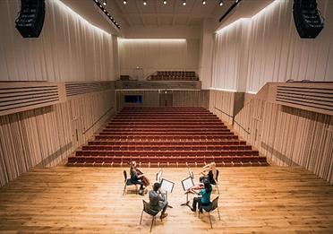four musicians on stage at The Stoller Hall