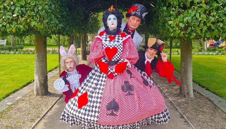 Actors dressed in Alice in Wonderland costumes