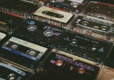 Collection of old audio tapes with titles 
