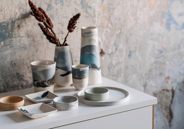Earthenware Products on White Table
