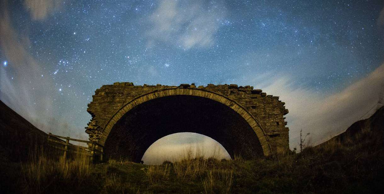 Old broken bridge and starry night sky