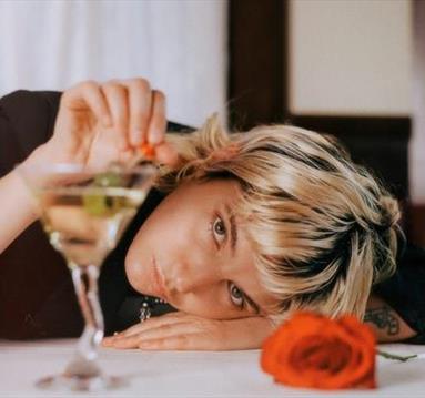 Caroline Rose next to martini glass and rose