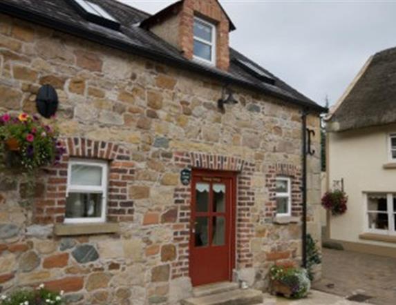 entrance to cottage with red door and stone walls