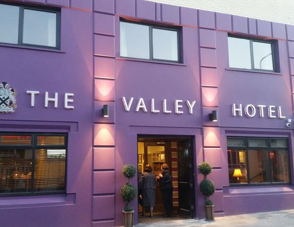 outside image of The Valley Hotel, with purple walls and black window frames and door