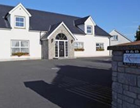 Outside photo of Kensington Lodge, white windows and black door