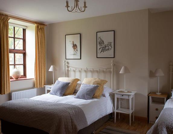 Spacious Triple bedroom with grey and yellow colour scheme