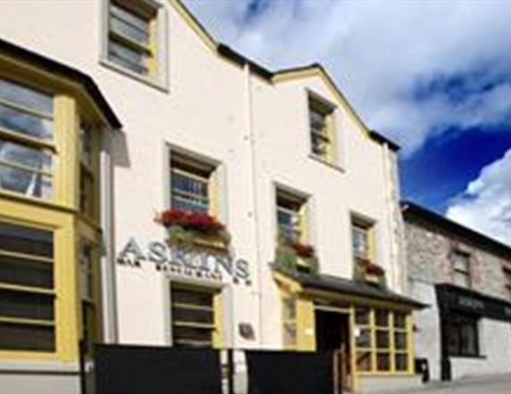 Outside image of The Tailor's house with yellow window frames and black door