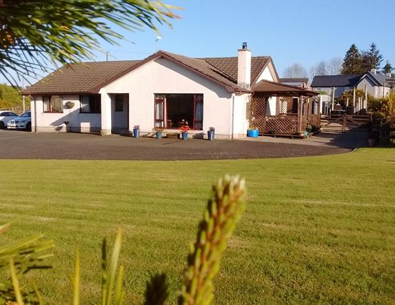 Outside view of house with large garden