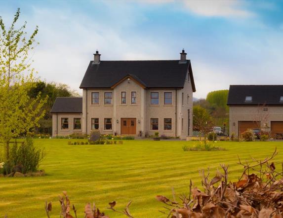 Outside view of 2 storey house with double garage and large garden