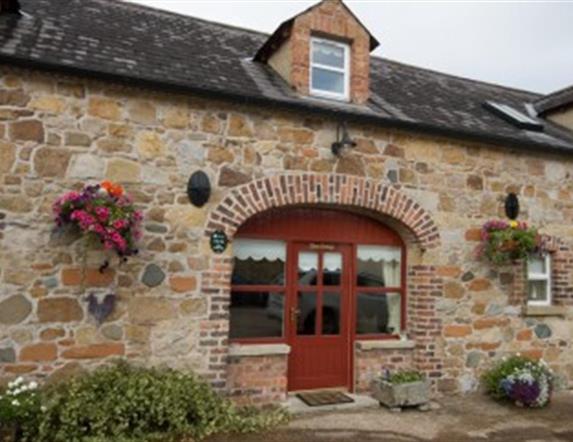 front door of cottage with stone walls