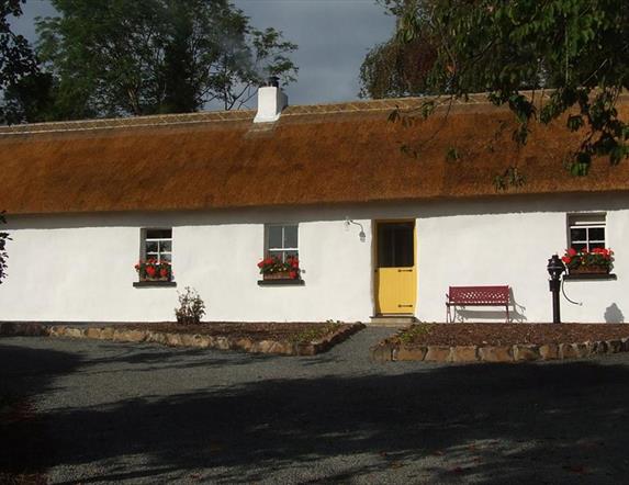 Outside image of cottage with yellow doors