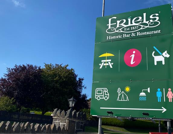 A picture of a sign post for Friels Bar and Restaurant