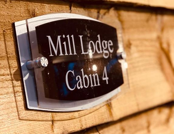 Sign of mill lodge cabin 4
