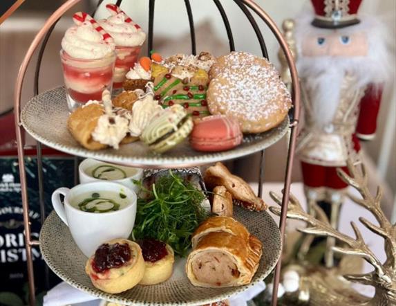 Image of an afternoon tray and a Nutcracker ornament in the background