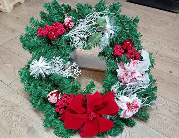 Image of a wreath with red and white accessories
