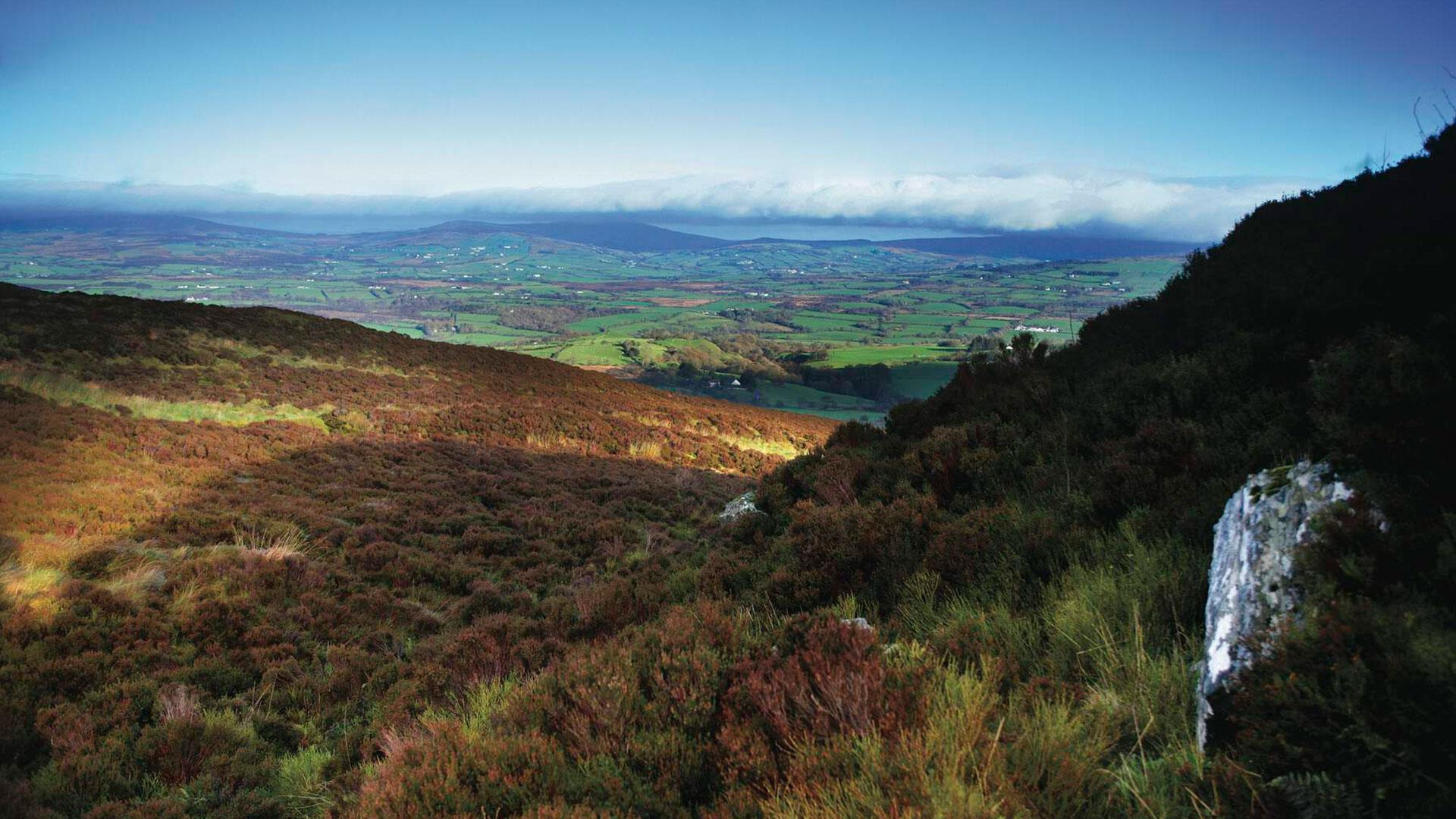A view from the Sperrin Mountains looking down the valley to Lough Neagh in the distance
